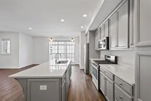 a kitchen with stainless steel appliances granite countertop a sink stove and cabinets