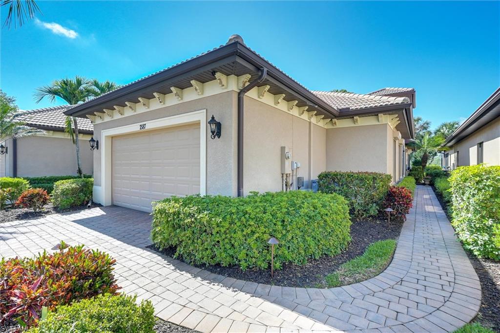 7587 Moorgate Point Way Naples, FL 34113 - Photo 1 of 50 Enclosed patio with brick paver flooring, screen enclosure, ceiling fans, and recessed lighting