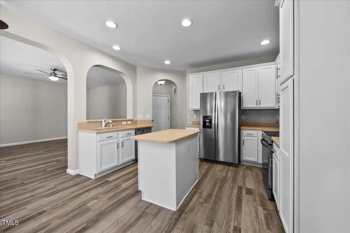 8404 Split Stone Lane Raleigh, NC 27613 - Photo 13 of 45 a kitchen with a refrigerator stove and wooden floor