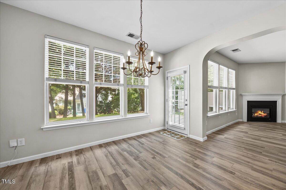 8404 Split Stone Lane Raleigh, NC 27613 - Photo 14 of 45 a view of an empty room with wooden floor and a window