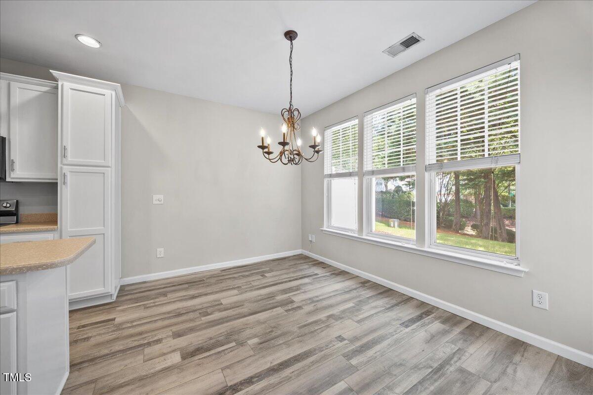 8404 Split Stone Lane Raleigh, NC 27613 - Photo 15 of 45 a view of a kitchen with a dishwasher cabinets and wooden floor
