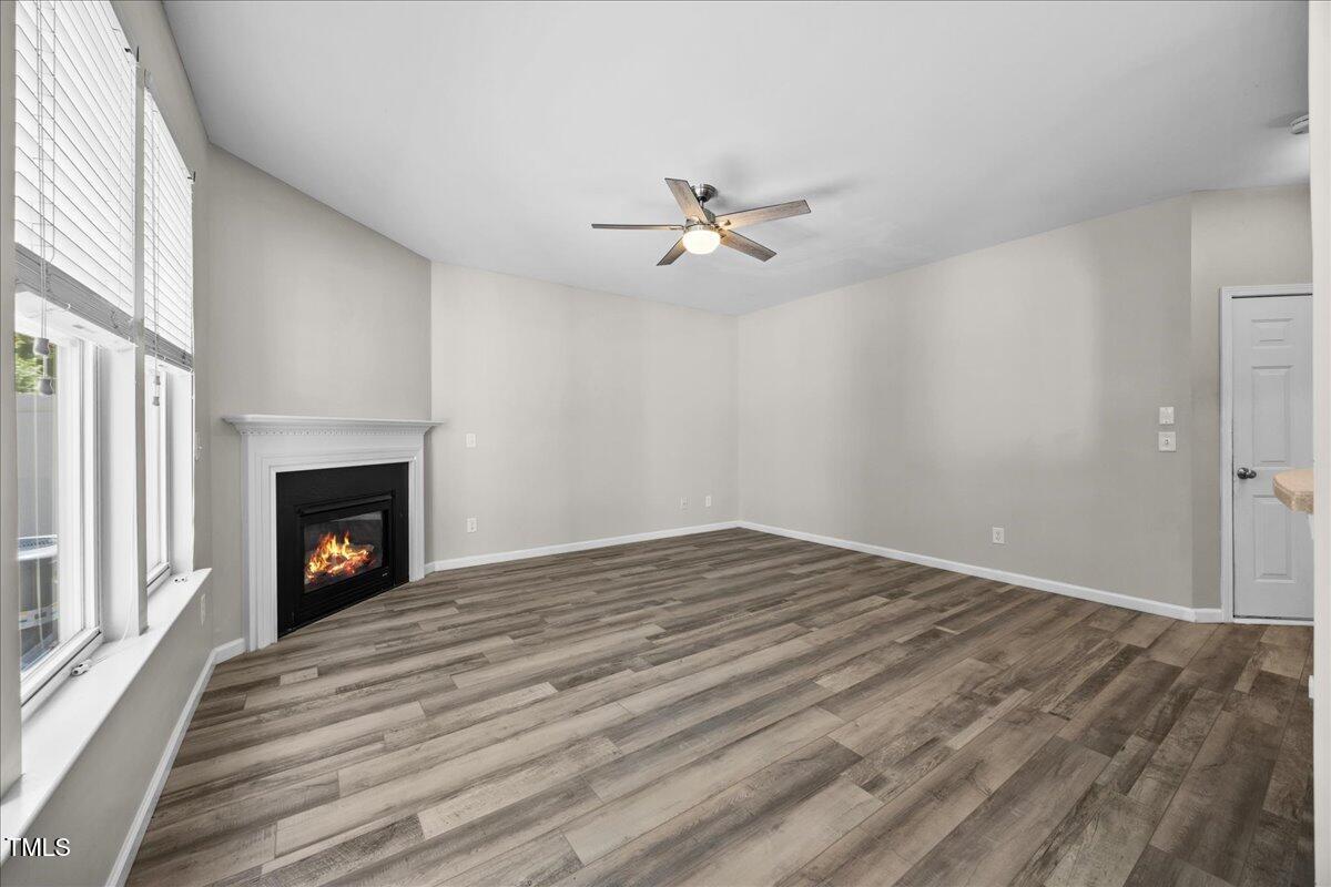 8404 Split Stone Lane Raleigh, NC 27613 - Photo 17 of 45 wooden floor in an empty room with a fireplace