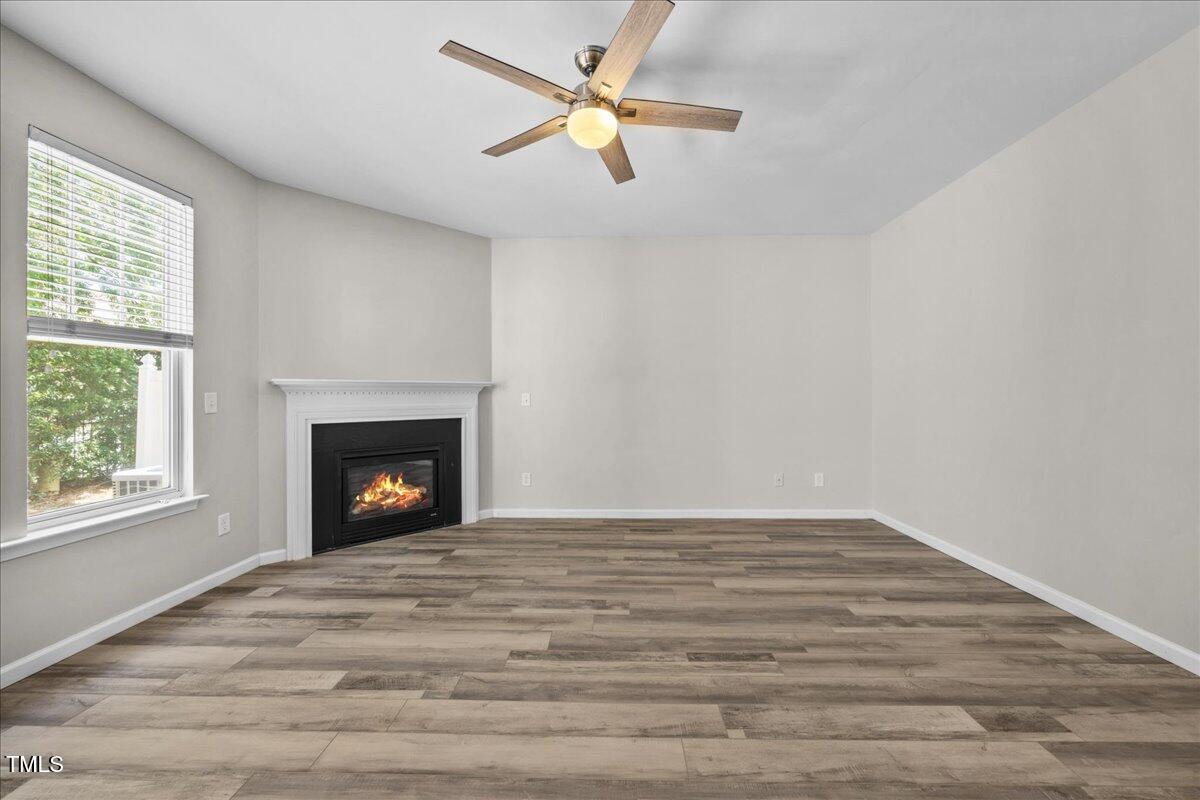 8404 Split Stone Lane Raleigh, NC 27613 - Photo 18 of 45 an empty room with windows and fireplace