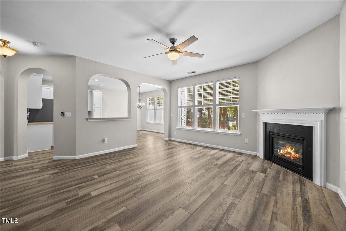 8404 Split Stone Lane Raleigh, NC 27613 - Photo 20 of 45 a view of an empty room with a fireplace and a window