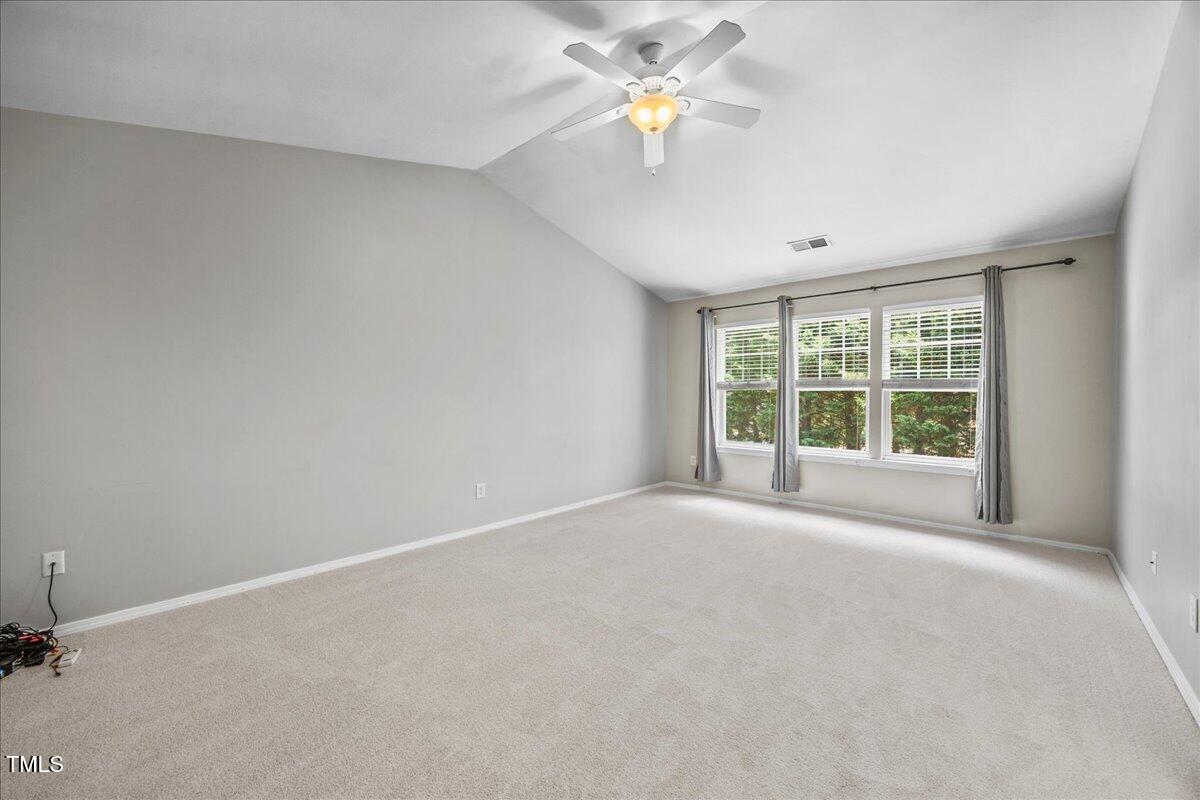 8404 Split Stone Lane Raleigh, NC 27613 - Photo 23 of 45 an empty room with a window and a ceiling fan