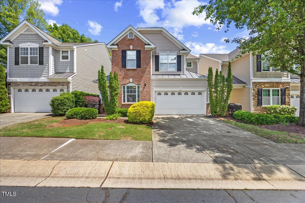 8404 Split Stone Lane Raleigh, NC 27613 - Photo 2 of 45 a front view of a house with a yard and garage