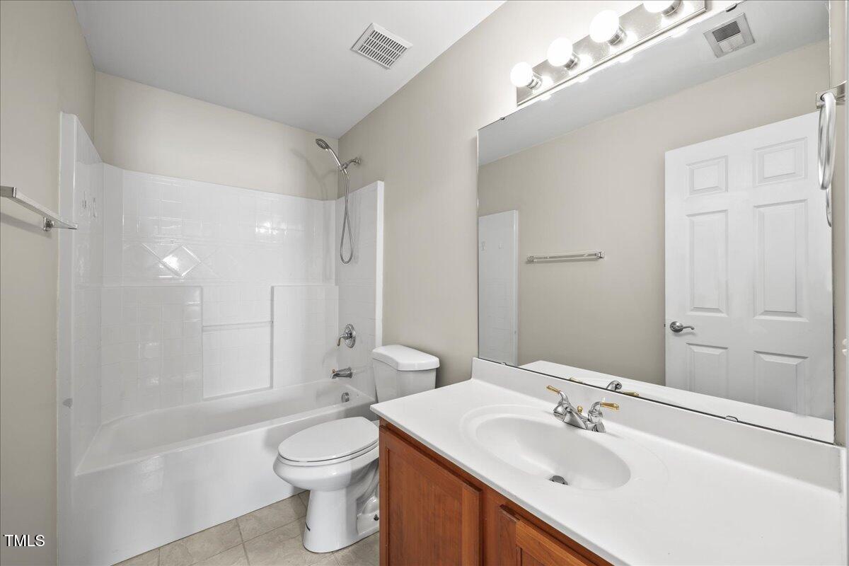 8404 Split Stone Lane Raleigh, NC 27613 - Photo 31 of 45 a bathroom with a sink a toilet and shower