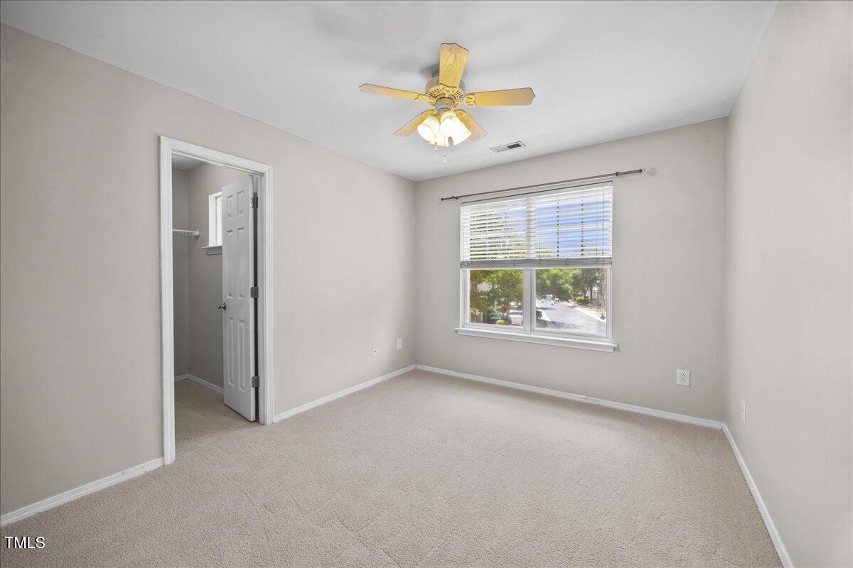 8404 Split Stone Lane Raleigh, NC 27613 - Photo 32 of 45 an empty room with a window and a fan