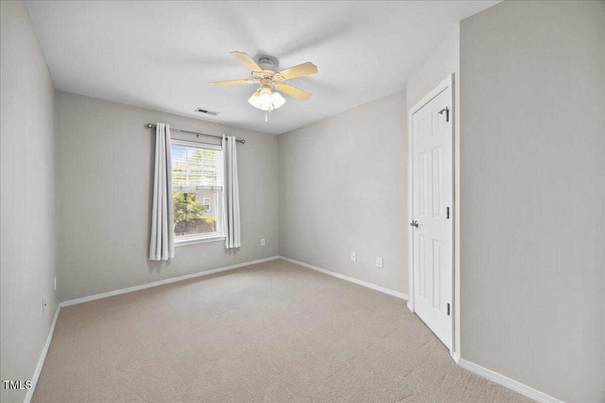 8404 Split Stone Lane Raleigh, NC 27613 - Photo 34 of 45 an empty room with windows and fan