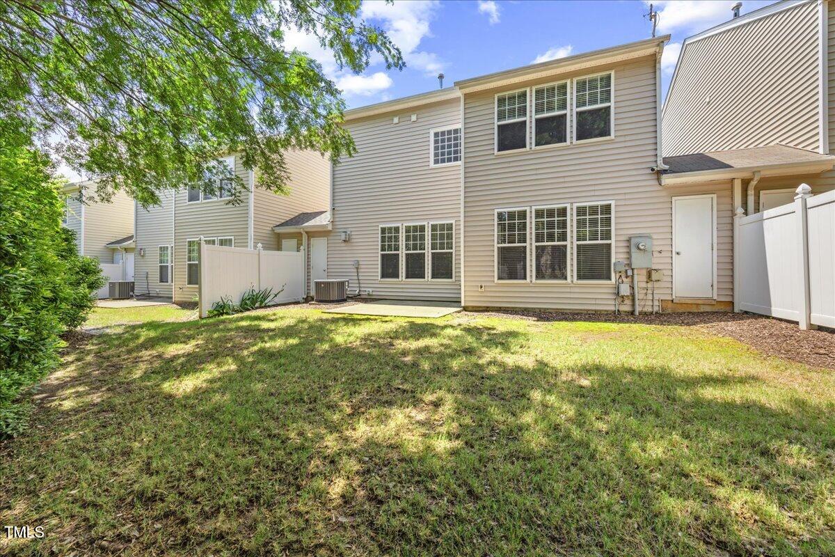 8404 Split Stone Lane Raleigh, NC 27613 - Photo 39 of 45 a large house with a large tree in front of it