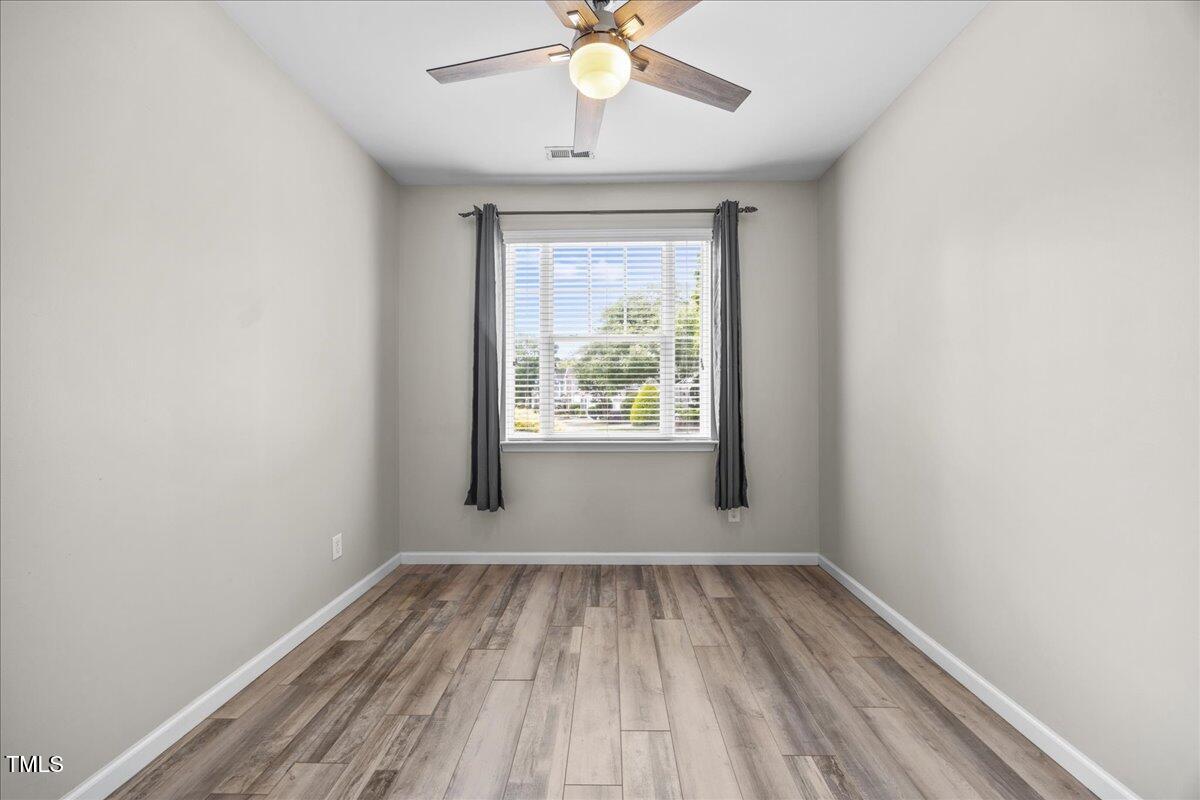 8404 Split Stone Lane Raleigh, NC 27613 - Photo 8 of 45 wooden floor in an empty room with a window