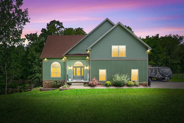 a front view of house with yard and green space