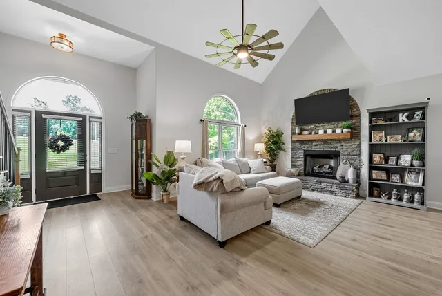a living room with furniture and a chandelier