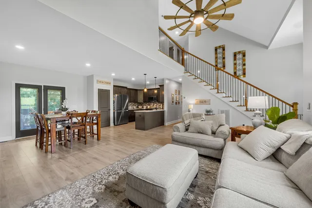 a kitchen with kitchen island a refrigerator sink and wooden floor