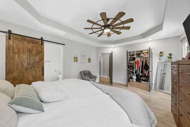 a bathroom with a double vanity sink a toilet a mirror and shower