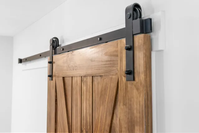 a view of staircase with railing and a rug