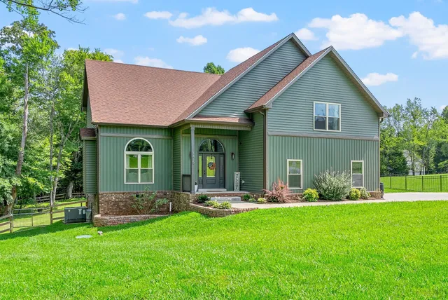 a front view of house with yard and green space