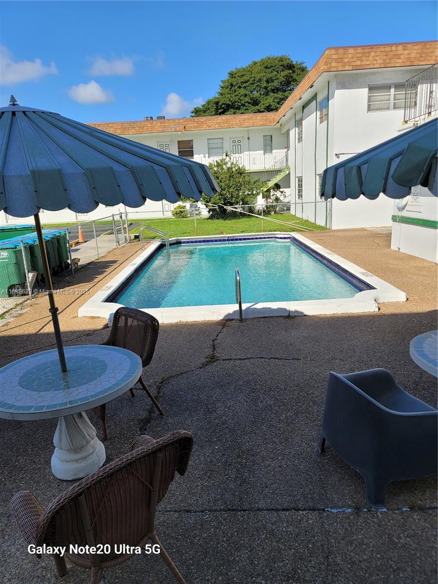 a view of a swimming pool with a lounge chairs