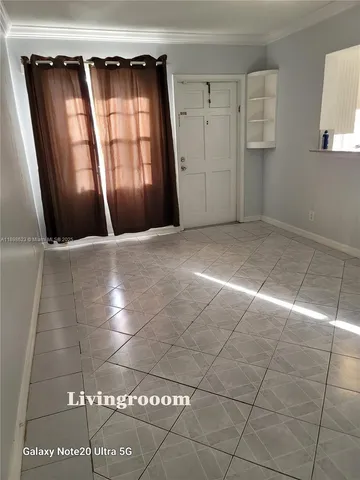 a view of an empty room with a window