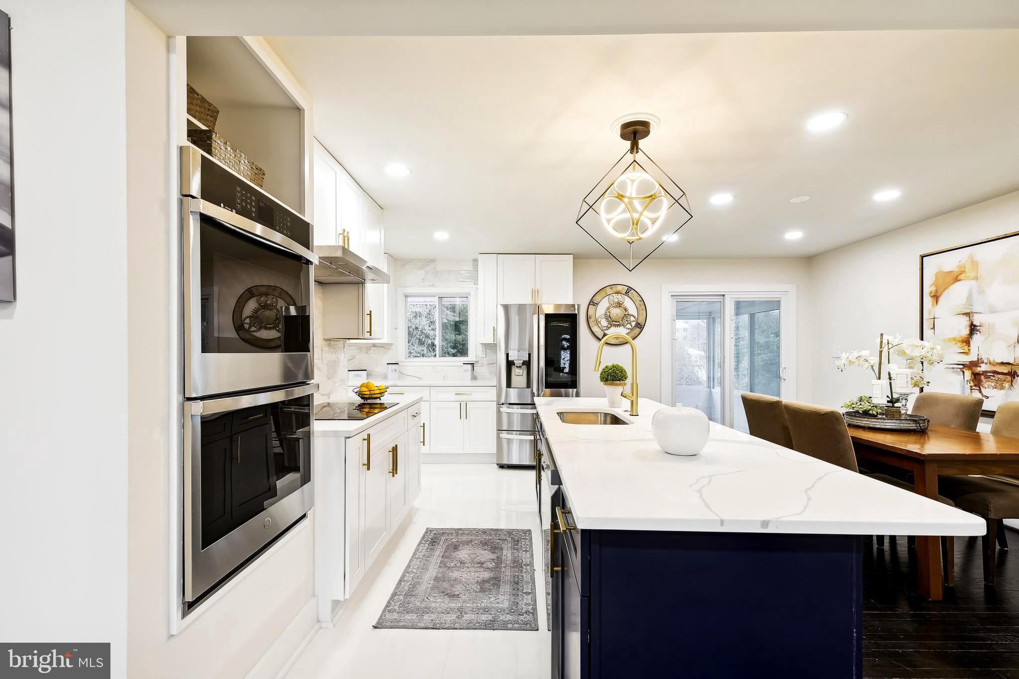 a view of a dining room kitchen island with stainless steel appliances granite countertop a stove top oven