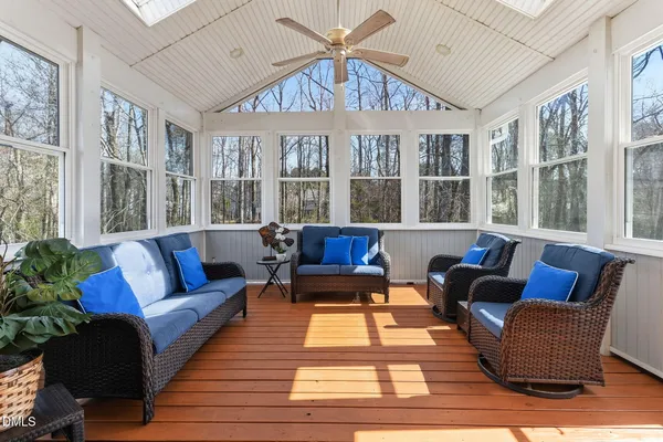 a view of an empty room with wooden floor and a fireplace