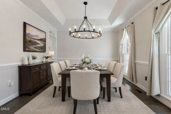 a living room with furniture a fireplace and a large window