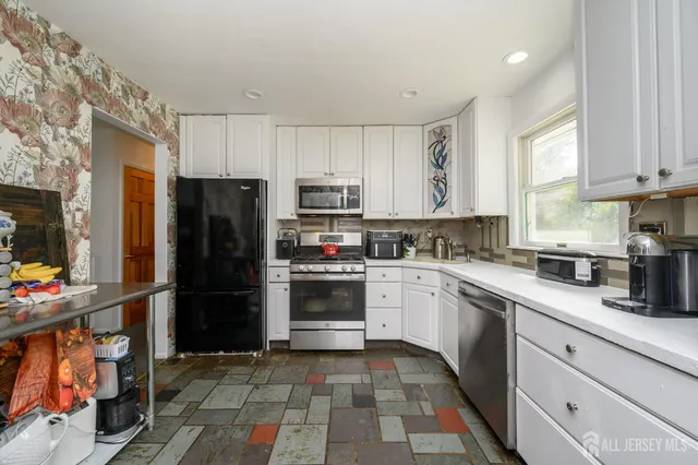 a kitchen with a refrigerator and a sink