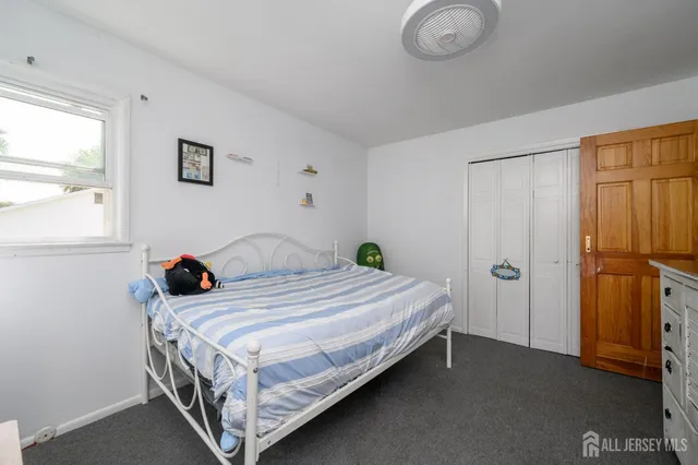 a bedroom with a bed and window