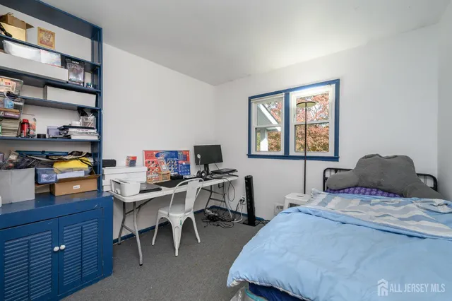 a bedroom with a bed and a desk in it