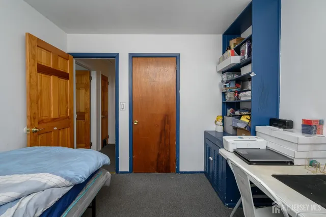 a bedroom with a bed and a bookshelf