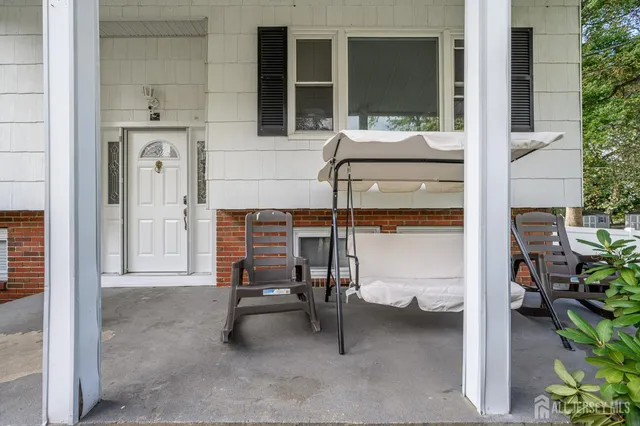 a balcony with table and chairs
