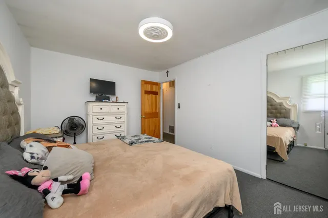 a bedroom with a bed and a tv