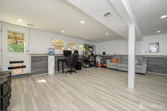 a view of a livingroom with furniture and workspace