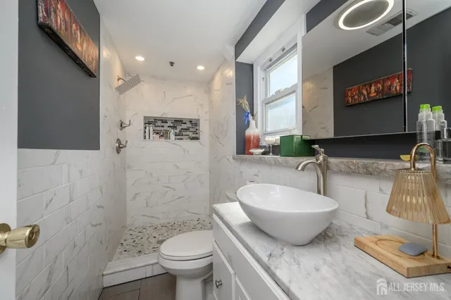 a spacious bathroom with a toilet sink and mirror