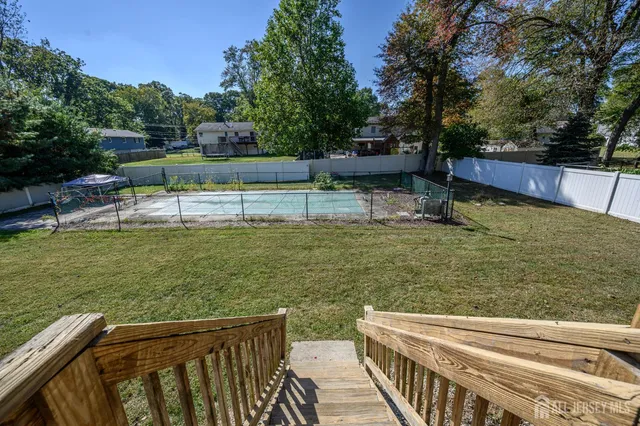 a view of a garden with large trees