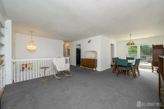 a view of a livingroom with furniture and a window