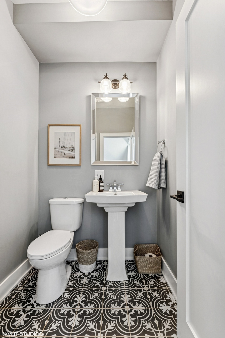 4328 North Ridgeway Avenue Chicago, IL 60618 - Photo 13 of 32 a bathroom with a sink toilet and mirror