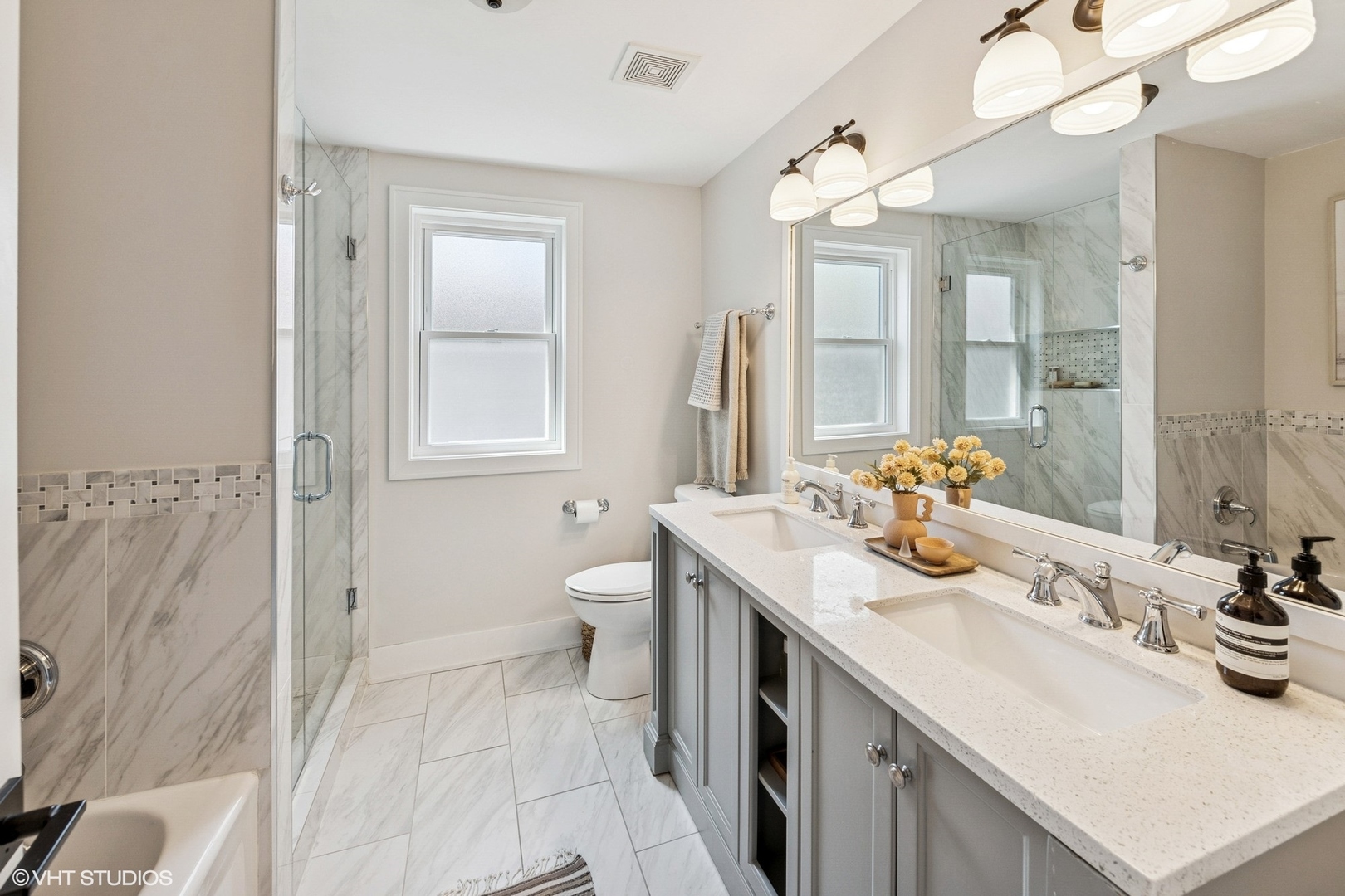 4328 North Ridgeway Avenue Chicago, IL 60618 - Photo 16 of 32 a bathroom with a sink double vanity and a mirror