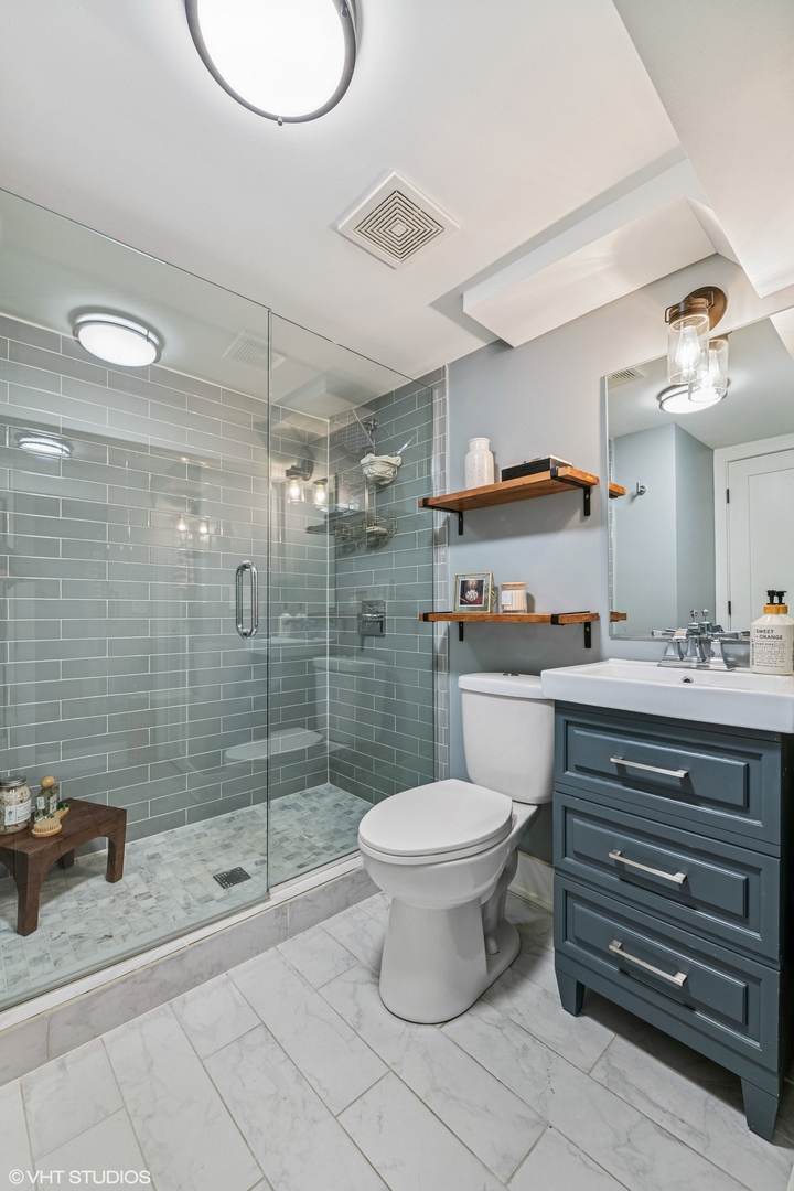 4328 North Ridgeway Avenue Chicago, IL 60618 - Photo 25 of 32 a bathroom with a toilet a sink and shower