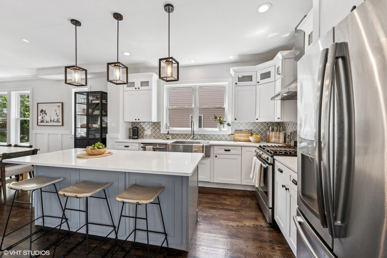 4328 North Ridgeway Avenue Chicago, IL 60618 - Photo 8 of 32 a kitchen with stainless steel appliances a stove a sink island and a refrigerator with wooden floor