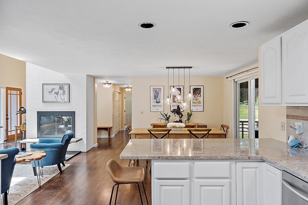 92 Sampson Road Bolton, MA 01740 - Photo 15 of 42 a kitchen with granite countertop a table and chairs in it