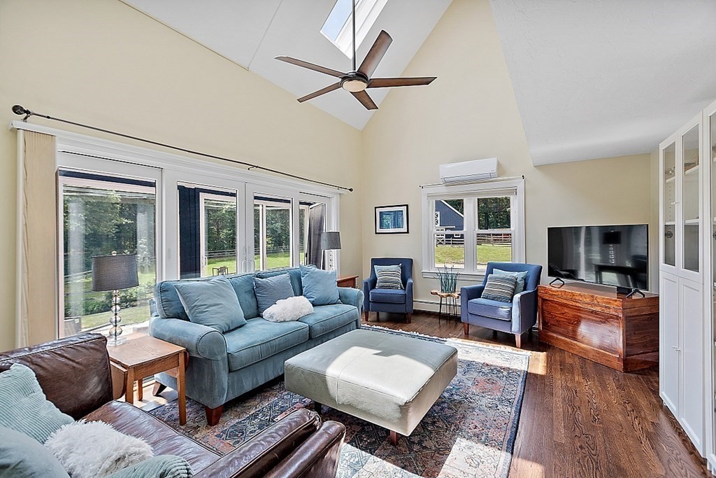 92 Sampson Road Bolton, MA 01740 - Photo 19 of 42 a living room with furniture a flat screen tv and a large window