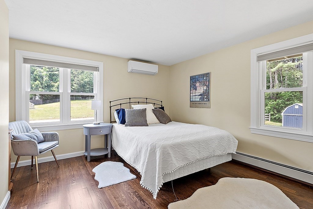 92 Sampson Road Bolton, MA 01740 - Photo 20 of 42 a bedroom with a bed and wooden floor