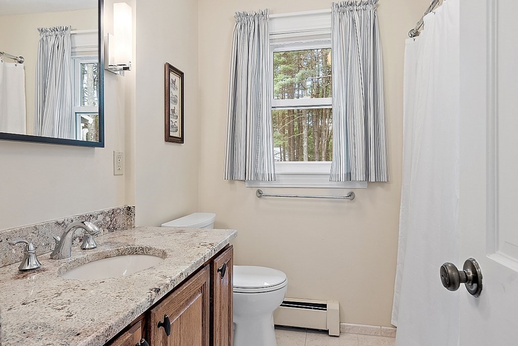 92 Sampson Road Bolton, MA 01740 - Photo 21 of 42 a bathroom with a granite countertop sink and a mirror