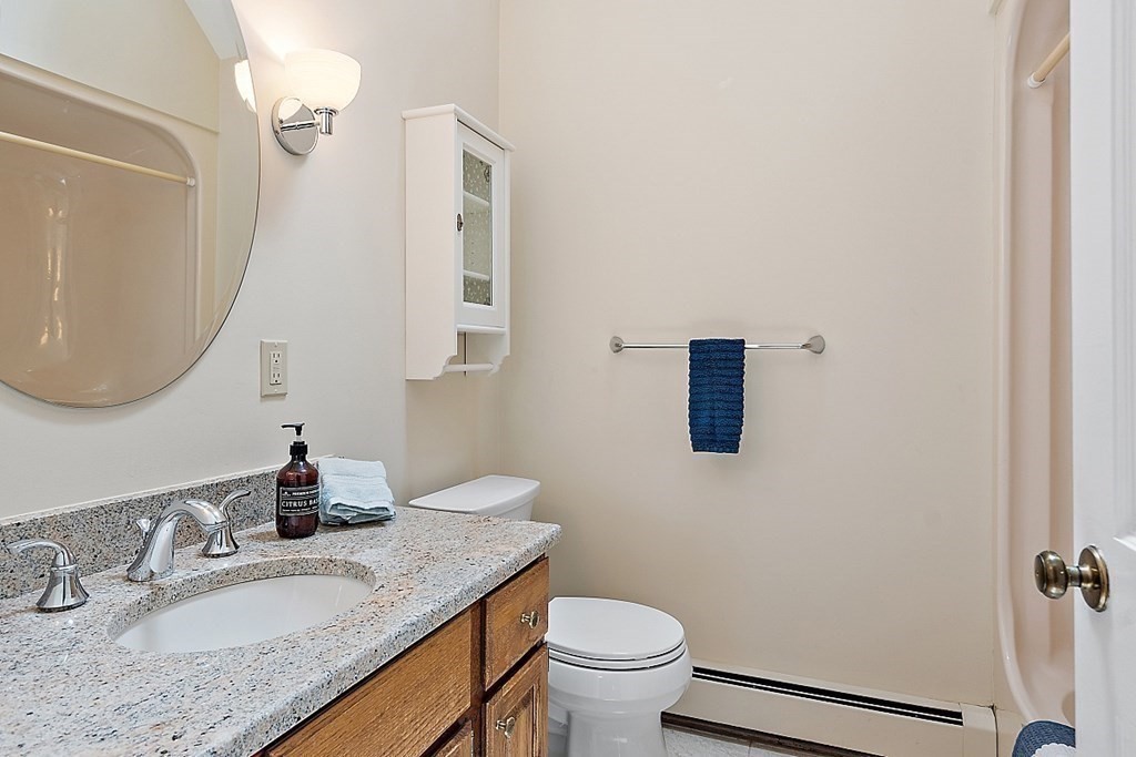 92 Sampson Road Bolton, MA 01740 - Photo 23 of 42 a bathroom with a granite countertop sink mirror vanity and toilet