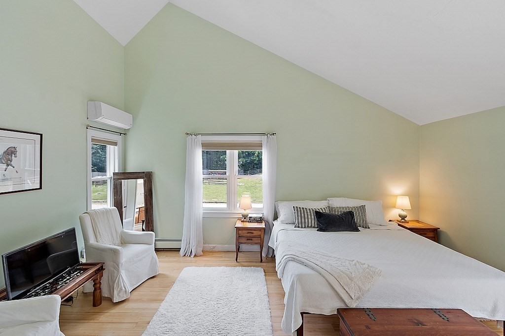 92 Sampson Road Bolton, MA 01740 - Photo 24 of 42 a bedroom with a bed and wooden floor