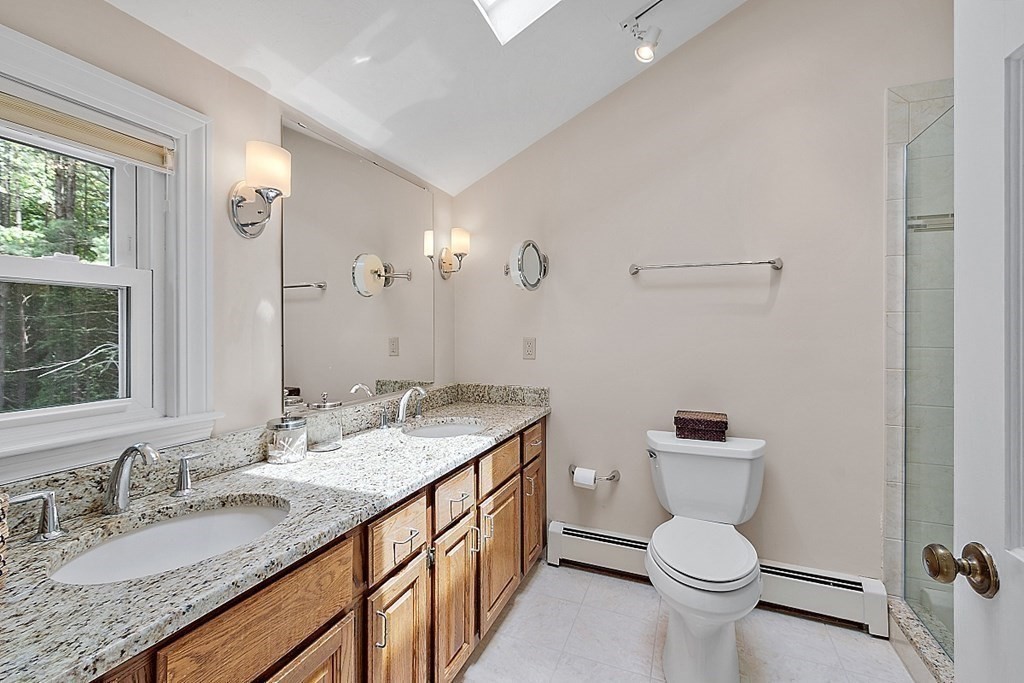 92 Sampson Road Bolton, MA 01740 - Photo 26 of 42 a bathroom with a granite countertop sink a toilet and a mirror