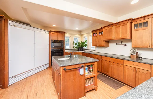 a kitchen with stainless steel appliances granite countertop a stove and a refrigerator