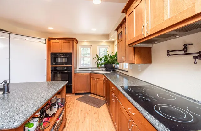 a room with table chairs and wooden floor