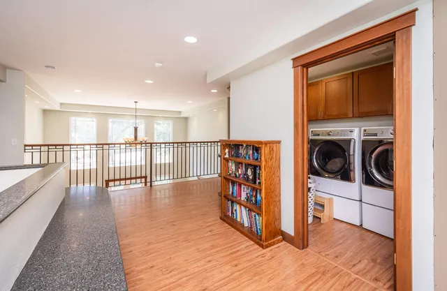 a view of a yard with plants and large trees